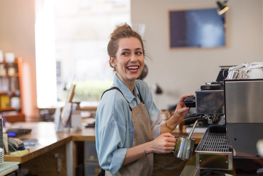 barista smiling in coffee shop